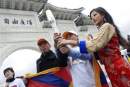 Miss Tibet passing torch for Tibetan Olympics. Image:AP